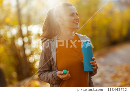happy stylish 40 years old woman in fitness clothes in park happy stylish 40 years old woman in fitness clothes in park 118443712
