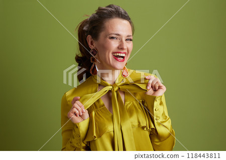 Portrait of happy fit woman isolated on green background Portrait of happy fit woman isolated on green background 118443811