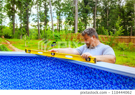 Construction of swimming pool in back yard of house 118444062