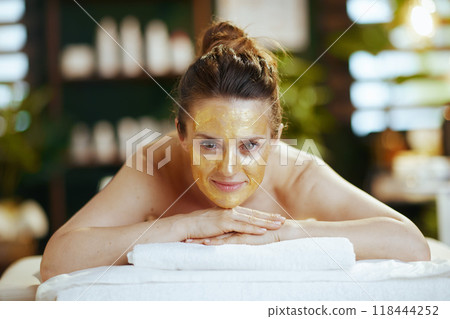 relaxed woman in massage cabinet laying on massage table 118444252