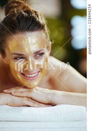 happy modern woman in spa salon laying on massage table happy modern woman in spa salon laying on massage table 118444254