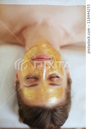 Upper view of relaxed woman in spa salon laying on massage table 118444255