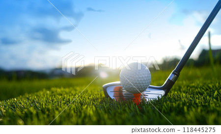 Golf clubs and balls on a green lawn in a beautiful golf course with morning sunshine. Golf clubs and balls on a green lawn in a beautiful golf course with morning sunshine. 118445275