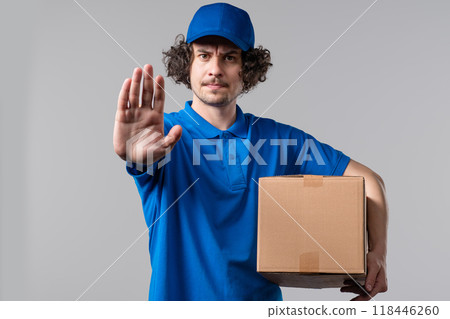 Serious postal courier man in blue rejecting gesture by stop sign. Refuse palms Serious postal courier man in blue rejecting gesture by stop sign. Refuse palms 118446260