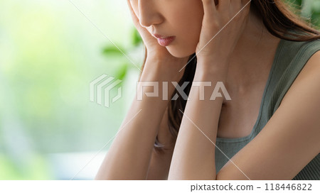 A worried young woman holding her head A worried young woman holding her head 118446822