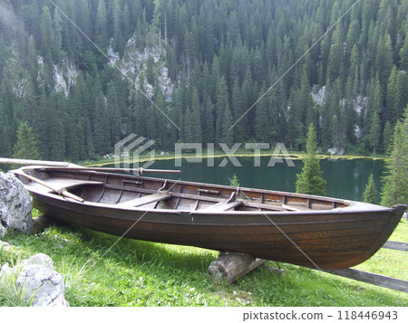 Rural boat standing near mountain forest and lake. Mountain panorama Rural boat standing near mountain forest and lake. Mountain panorama 118446943