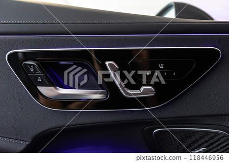 Car door interior, showcasing luxurious leather materials and advanced seat adjustment controls Car door interior, showcasing luxurious leather materials and advanced seat adjustment controls 118446956