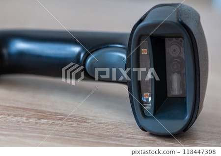 Handheld scanner on a wooden table 118447308