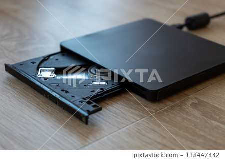 A black DVD-ROM on a wooden table 118447332