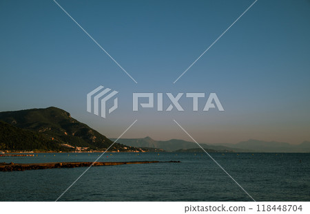 The sky is blue and the mountains are in the background 118448704