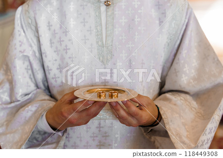 Elegant Ceremony with Gold Wedding Rings on Ornate Silver Platter 118449308