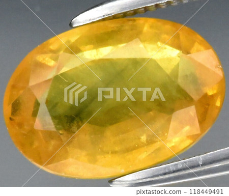 Radiant Oval Cut Yellow Sapphire Gemstone with Gleaming Facets Captured in a Delicate Hold 118449491