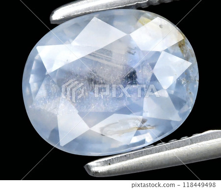 Stunning Faceted Blue Sapphire Gemstone Held by Metal Tweezers Highlighting Its Translucent Beauty 118449498