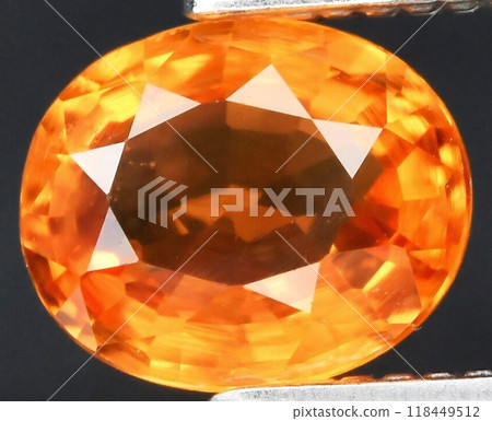 Brilliant Close-up of Faceted Orange Gemstone with Intricate Detailing and Radiant Illumination Brilliant Close-up of Faceted Orange Gemstone with Intricate Detailing and Radiant Illumination 118449512