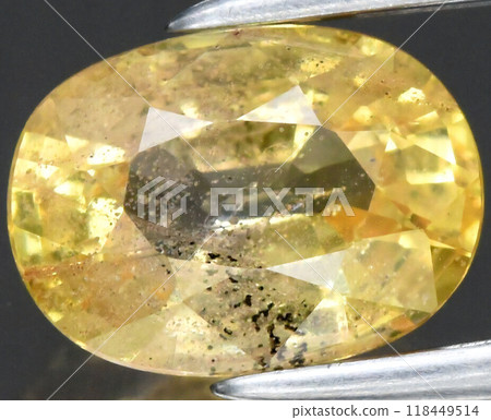 Radiant Yellow Sapphire Gemstone with Intricate Facets and Unique Inclusions Captured in Detailed Close-Up Radiant Yellow Sapphire Gemstone with Intricate Facets and Unique Inclusions Captured in Detailed Close-Up 118449514