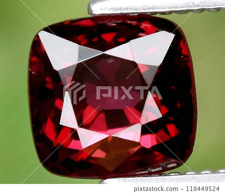 Radiant Red Garnet Gemstone in Pristine Clarity Displayed with Metallic Tweezers 118449524