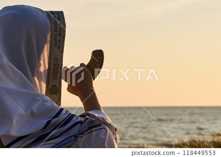 Jewish man blowing the Shofar rams horn on Rosh Hashanah and Yom Kippur day. Jewish man blowing the Shofar rams horn on Rosh Hashanah and Yom Kippur day. 118449553