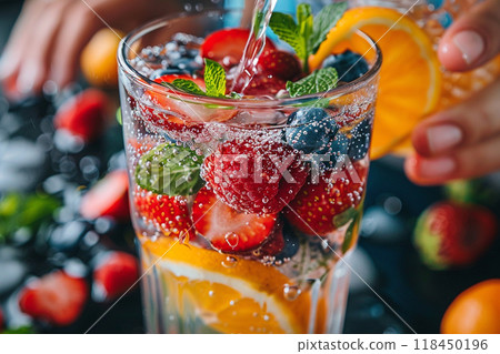 Fruit Infused Sparkling Water. Close-up of refreshing sparkling water with a variety of fruits and mint leaves. 118450196