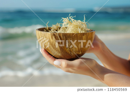 Hand-Held Wooden Bowl at the Beach Hand-Held Wooden Bowl at the Beach 118450569