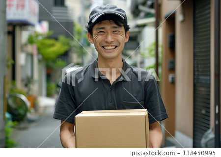 Cheerful Delivery Man Holding a Package 118450995