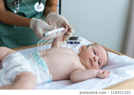 Unrecognizable doctor checking newborn baby's blood sugar level Unrecognizable doctor checking newborn baby's blood sugar level 118451101