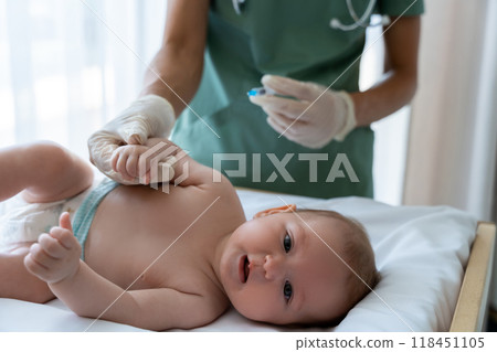 Medical professional carefully vaccinating young child with syringe during injection 118451105