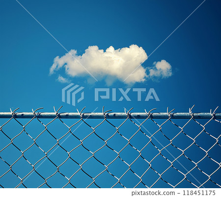 Cloud Behind Barbed Chain-Link Fence Cloud Behind Barbed Chain-Link Fence 118451175