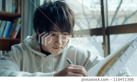 Focused Student Studying with Notebook Focused Student Studying with Notebook 118451306