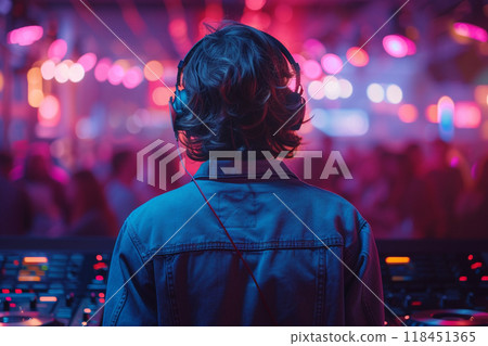 DJ at the Turntable in a Vibrant Club Setting DJ at the Turntable in a Vibrant Club Setting 118451365