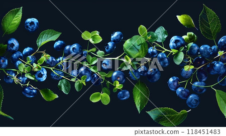 Fresh blueberries are elegantly swirling with lush green leaves, creating a visually striking and dynamic effect against a dark backdrop 118451483
