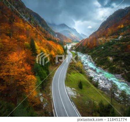 Aerial view of curvy road and orange forest in mountains in fall 118451774