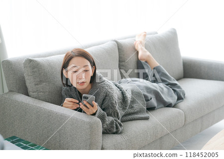 Woman taking a nap on the sofa Woman taking a nap on the sofa 118452005