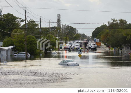 Hurricane Debby flooded city street with trapped car submerged under water in Florida residential area. Consequences of natural disaster 118452091