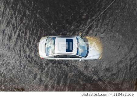 Hurricane flooded car on city street in surrounded with water Florida residential area. Consequences of hurricane Debby natural disaster Hurricane flooded car on city street in surrounded with water Florida residential area. Consequences of hurricane Debby natural disaster 118452109