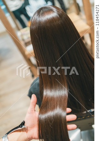 A beautiful long-haired female customer at a beauty salon 118454271