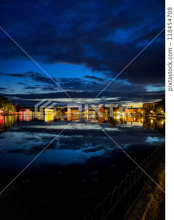 The skyline of Sweden. A night shot with picturesque water reflections, featuring houses by the Melaren River. Eskilstuna. 118454708