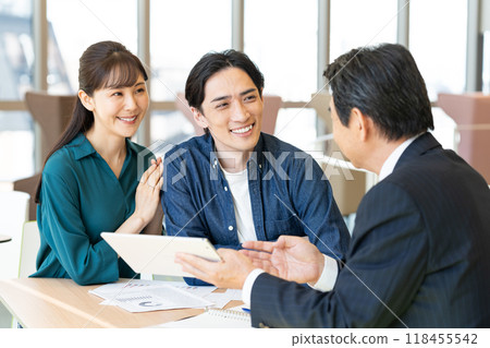 A middle-aged couple consulting each other. Photo courtesy of Denpa Gakuen, Tokyo Electronics College. 118455542