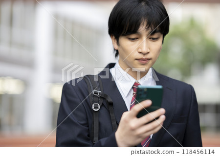 High school boy looking at smartphone screen Photography cooperation: Ariake College of Education and Arts High school boy looking at smartphone screen Photography cooperation: Ariake College of Education and Arts 118456114