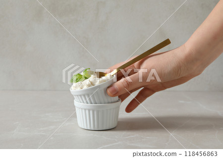Ricotta in a bowl with herbs on a light background Ricotta in a bowl with herbs on a light background 118456863