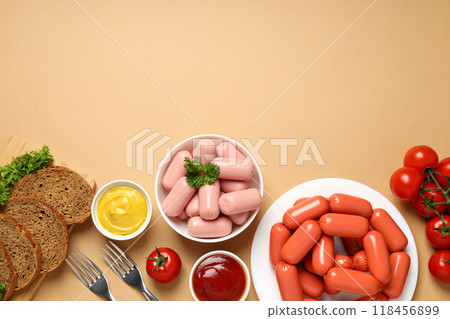 Small sausages in a bowl with fresh tomatoes and bread 118456899