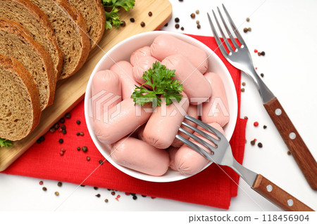 Small sausages in a bowl with parsley and bread Small sausages in a bowl with parsley and bread 118456904