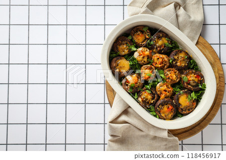 Stuffed mushrooms on wooden board and towel on light background, space for text Stuffed mushrooms on wooden board and towel on light background, space for text 118456917