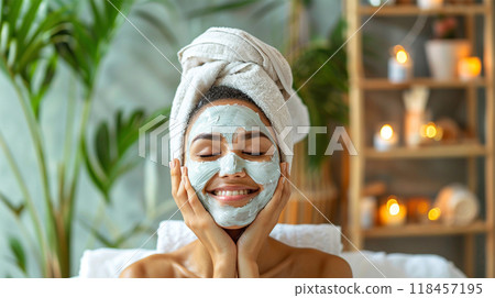Relaxed woman enjoying spa treatment with face mask 118457195