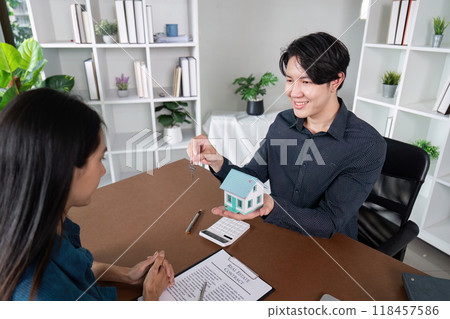 Real Estate Agent Finalizing Deal with Key Handover to Client Real Estate Agent Finalizing Deal with Key Handover to Client 118457586