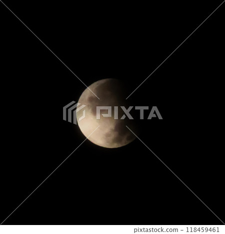 Partial Lunar Eclipse Night Sky.A dramatic night sky photo taken during a partial lunar eclipse.  118459461