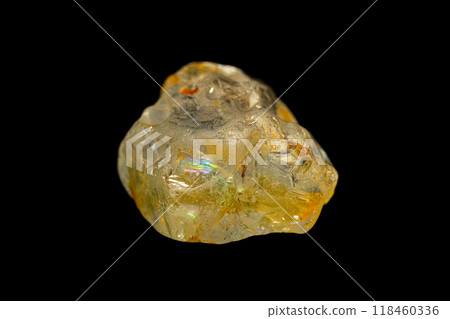 Rough Topaz gemstone on dark background Rough Topaz gemstone on dark background 118460336