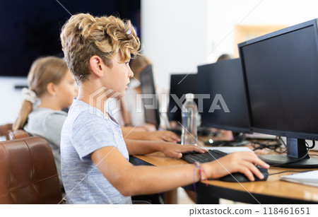 Boy student learning to work on computer in classroom 118461651