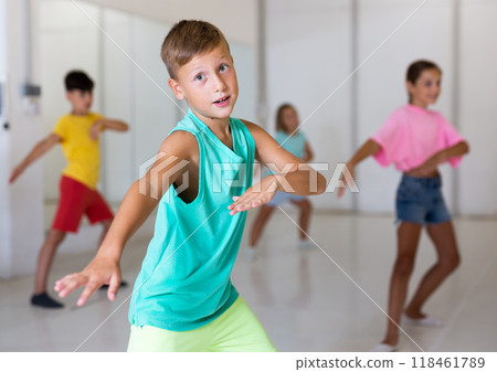Group of fashionable children learning a modern dance while having choreography class. Dance studio 118461789