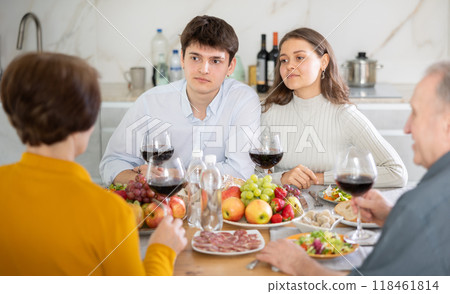 Cheerful young couple having dinner with elderly parents 118461814