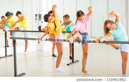 Preteen girls practicing ballet positions near bar in choreographic school Preteen girls practicing ballet positions near bar in choreographic school 118461962